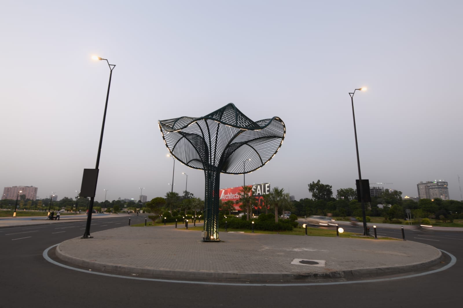 CBD Vertex canopy structure on CBD Route 47 roundabout in Lahore at dusk