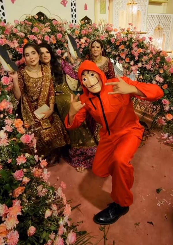The picture shows bride's cousin stealing groom's shoes.