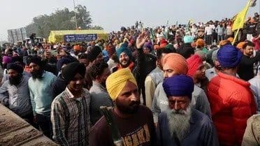 What are the demands of Indian farmers protesting in new Delhi?
