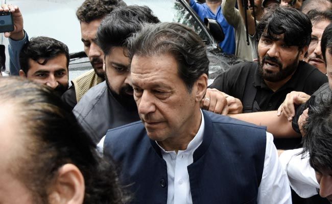 Former prime minister Imran Khan (C) arrives at Lahore High Court on May 15, 2023