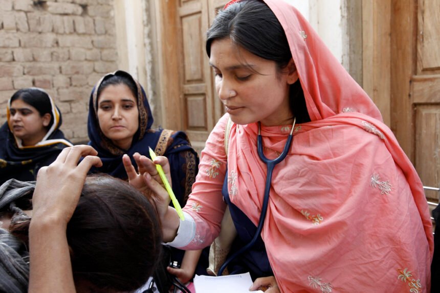 A female doctor with the International Medical Corps examines a woman patient at a mobile health clinic in Pakistan